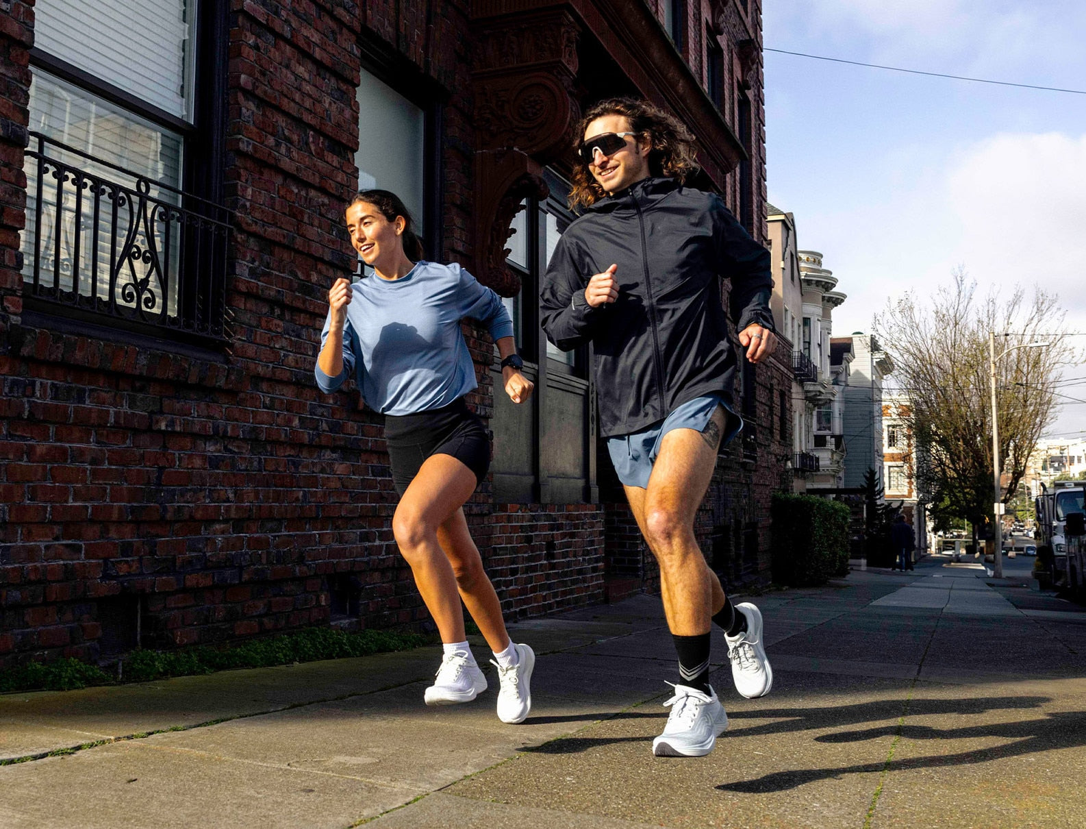 Two runners showcasing road running shoes.