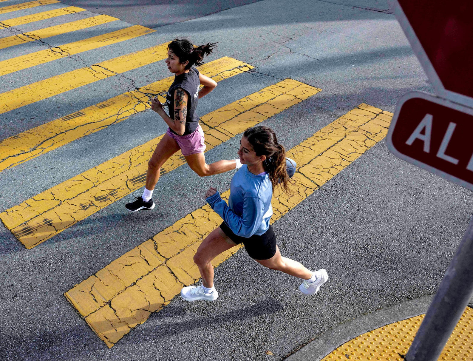 Two runners showcasing women's road running shoes.