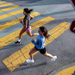 Two runners showcasing women's road running shoes.